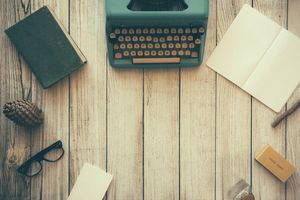 Planning blog content with a typewriter and notebook